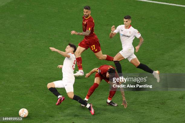 Lucas Ocampos of Sevilla FC goes down in the box after a challenge from Roger Ibanez of AS Roma, which was not given as a penalty after a Video...