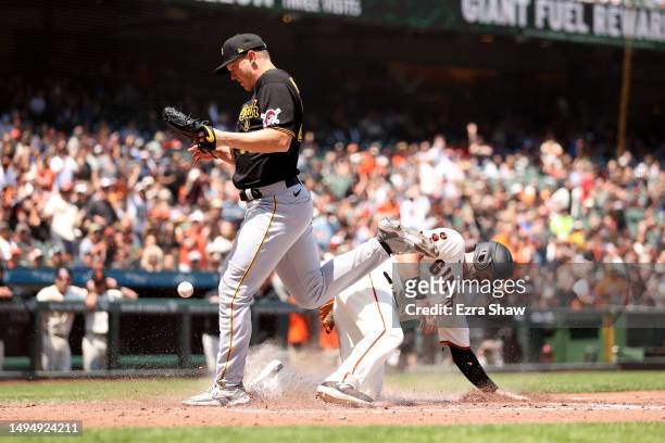 Mike Yastrzemski of the San Francisco Giants scores on a wild pitch thrown by Mitch Keller of the Pittsburgh Pirates in the fifth inning at Oracle...
