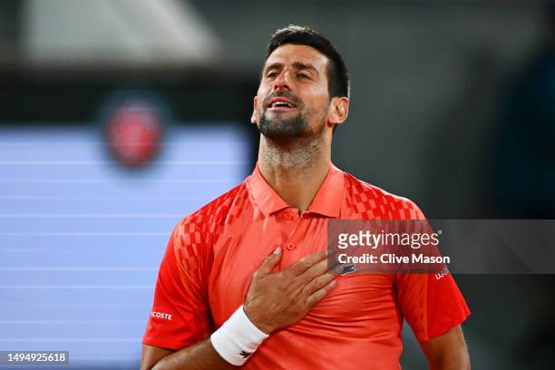 Novak Djokovic of Serbia celebrates winning match point against Marton Fucsovics of Hungary during the Men's Singles Second Round Match on Day Four...