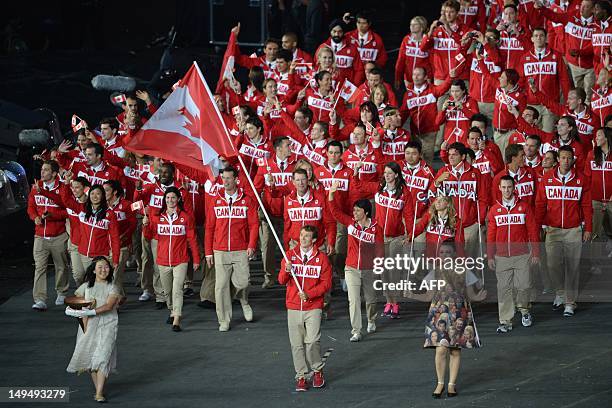 Canada's flagbearer Simon Whitfield leads his country's delegation during the opening ceremony of the London 2012 Olympic Games on July 27, 2012 at...