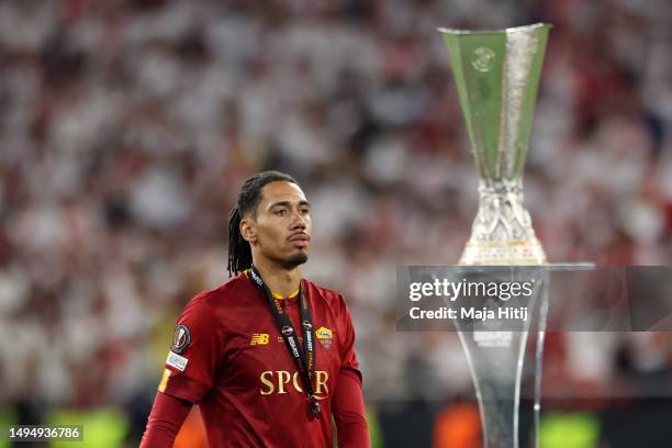 Chris Smalling of AS Roma walks past the UEFA Europa League Trophy following their side's defeat to Sevilla FC in the penalty shoot during the UEFA...