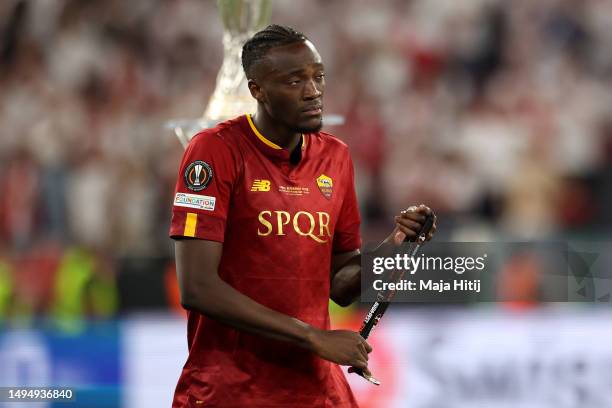 Tammy Abraham of AS Roma walks past the UEFA Europa League Trophy as they remove their runners up medal following their side's defeat to Sevilla FC...