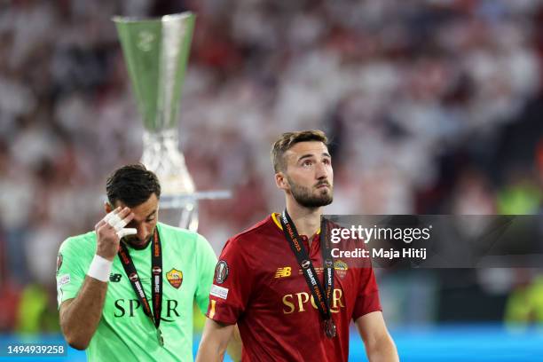 Bryan Cristante of AS Roma walks past the UEFA Europa League Trophy with their runners up medal following their side's defeat to Sevilla FC in the...