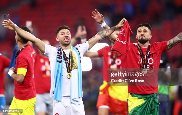 Gonzalo Montiel and Alex Telles of Sevilla FC celebrate whilst wearing their winners medal after the team's victory in the UEFA Europa League 2022/23...