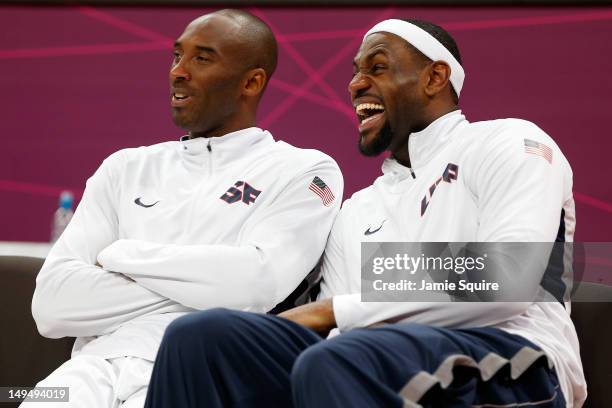 Kobe Bryant and LeBron James of the United States smile while on the bench against France in the Men's Basketball Game on Day 2 of the London 2012...