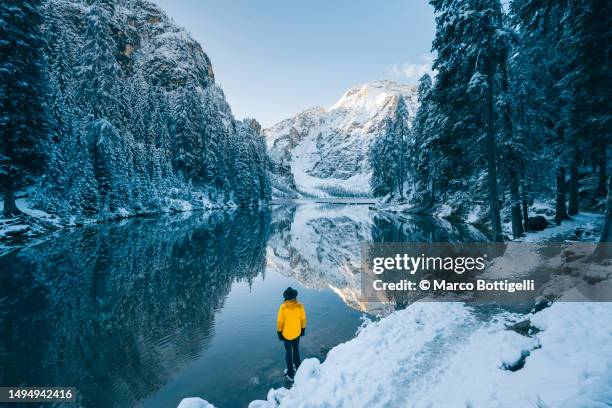 man admiring a mountain lake in winter scenery - european alps stock pictures, royalty-free photos & images