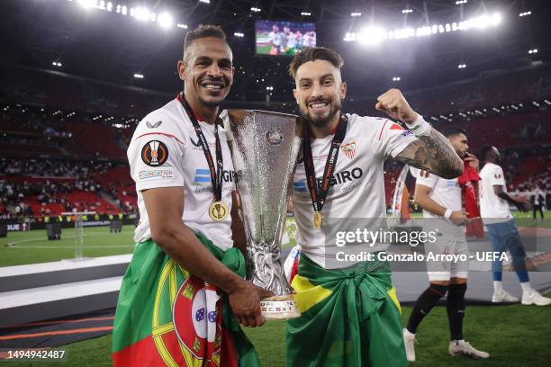 Fernando and Alex Telles of Sevilla FC pose for a photograph with the UEFA Europa League trophy after the team's victory during the UEFA Europa...