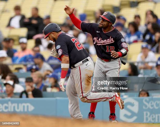 Keibert Ruiz of the Washington Nationals celebrates his second homerun of the game with Eric Young Jr. #12, to take a 10-6 lead over the Los Angeles...