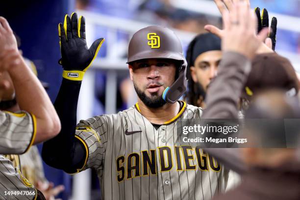 Gary Sanchez of the San Diego Padres high fives teammates after hitting a home run against the Miami Marlins during the third inning at loanDepot...