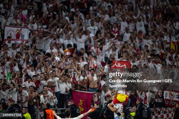 Jesus Navas of Sevilla celebates victory on the sholuders of Lucas Ocampos with the Sevilla Fans after the UEFA Europa League 2022/23 final match...