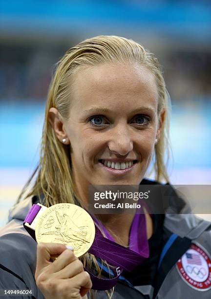 Gold medallist Dana Vollmer of the United States celebrates after winning the gold medal and setting a new world record time of 55.98 seconds in the...