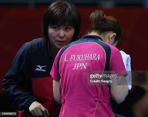 Ai Fukuhara of Japan speaks to the Japan team coach in her Women's Singles Table Tennis third round match against Anna Tikhomirova of Russia on Day 2...