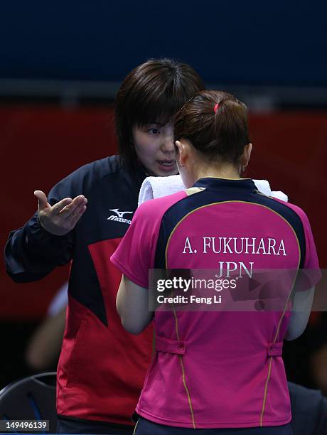 Ai Fukuhara of Japan speaks to the Japan team coach in her Women's Singles Table Tennis third round match against Anna Tikhomirova of Russia on Day 2...