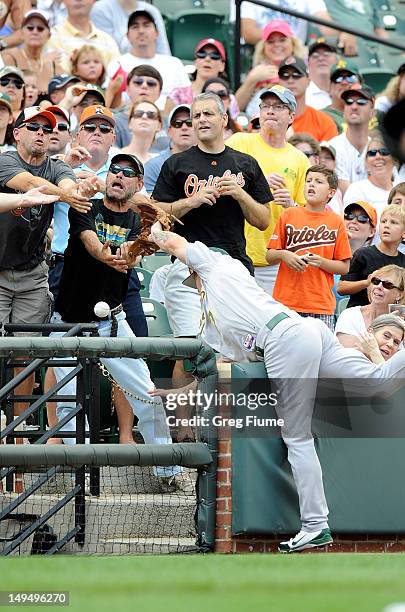 Brandon Inge of the Oakland Athletics tries to catch a foul ball in the stands during the game against the Baltimore Orioles at Oriole Park at Camden...