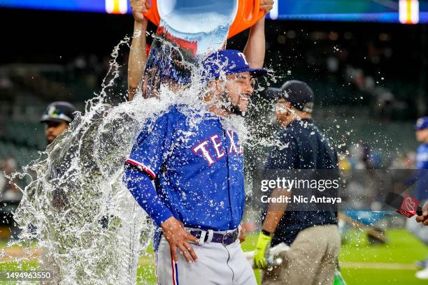 Water is dumped on Grant Anderson of the Texas Rangers while he is interviewed after the win against the Detroit Tigers at Comerica Park on May 30,...