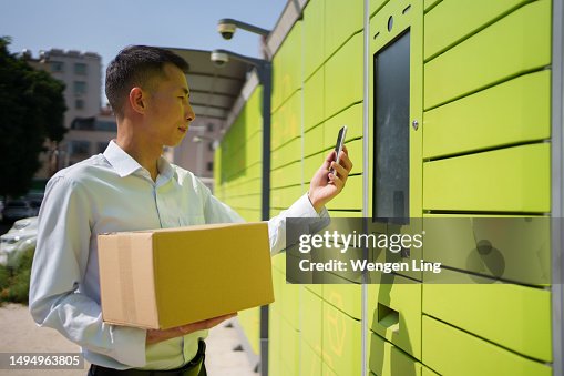 Man using self-service smart parcel mail locker Man using self-service smart parcel mail locker