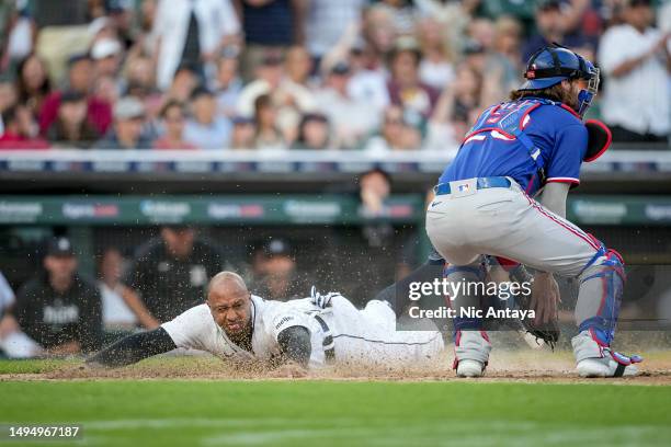 Jonathan Schoop of the Detroit Tigers slides home against Jonah Heim of the Texas Rangers during the bottom of the fifth inning at Comerica Park on...