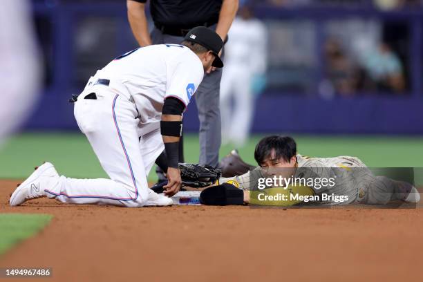 Ha-Seong Kim of the San Diego Padres slides to second base against Luis Arraez of the Miami Marlins during the third inning at loanDepot park on May...