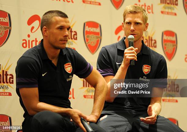 Per Mertesacker and Lukas Podolski of Arsenal FC attend an Arsenal Fans Party at the Eko Hotel on July 29, 2012 in Lagos, Nigeria.