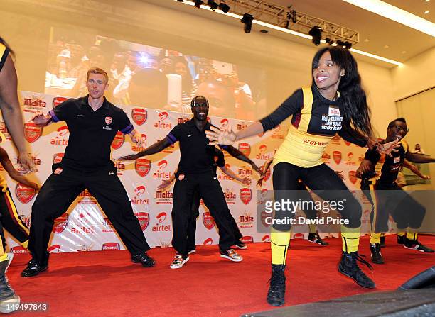 Per Mertesacker and Bacary Sagna of Arsenal FC dance during an Arsenal Fans Party at the Eko Hotel on July 29, 2012 in Lagos, Nigeria.