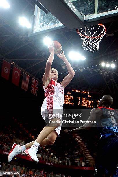 Andrey Kirilenko of Russia dunks the ball against Luol Deng of Great Britain during their Men's Basketball Game on Day 2 of the London 2012 Olympic...