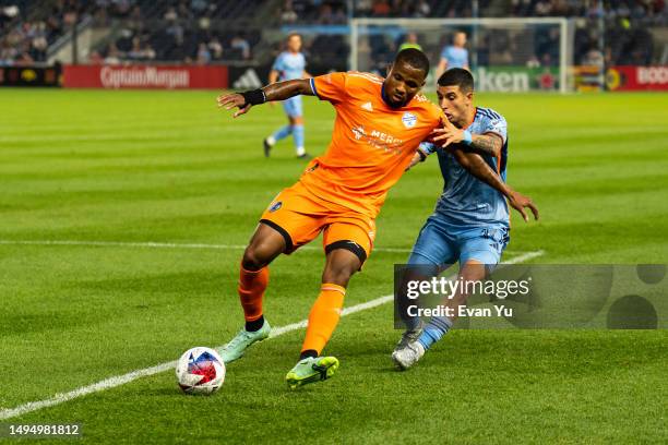 Alvas Powell of FC Cincinnati and Santiago Rodriguez of New York City Football Club battle for the ball during the second half at Yankee Stadium on...
