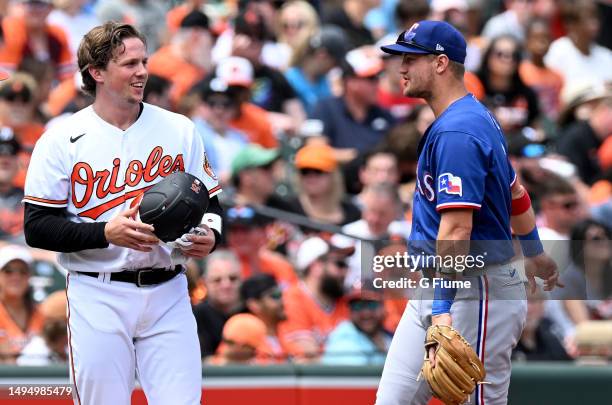 Adley Rutschman of the Baltimore Orioles talks with Josh Jung of the Texas Rangers during the game at Oriole Park at Camden Yards on May 28, 2023 in...