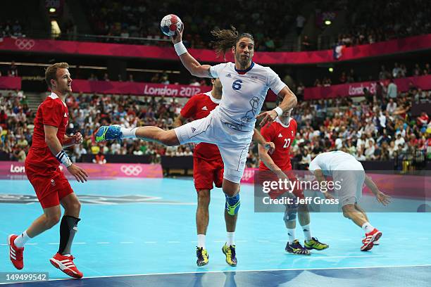 Bertrand Gille of France jumps to shoot during the Men's Handball preliminaries group A match between France and Great Britain on Day 2 of the London...