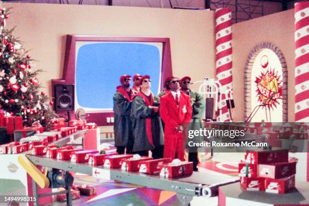 Professional NFL and MLB player Deion Sanders, on both the Atlanta Braves and Atlanta Falcons teams, is ready to be filmed in a red suit surrounded...