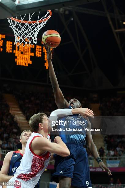 Luol Deng of Great Britain goes for a layup against Timofey Mozgov of Russia during their Men's Basketball Game on Day 2 of the London 2012 Olympic...