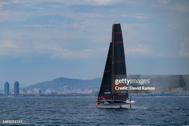 The Alinghi Red Bull Racing AC40 sails pass the Barcelona skyline during a training session on May 31, 2023 in Barcelona, Spain. The Alinghi Red Bull...