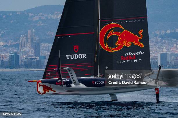 The Alinghi Red Bull Racing AC40 sails pass the Barcelona skyline with the Sagrada Familia in the background during a training session on May 31,...
