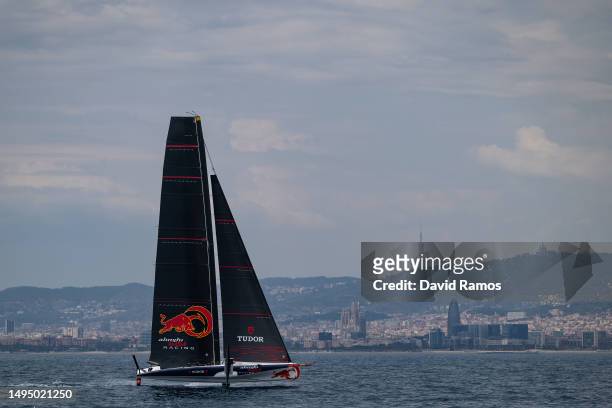 The Alinghi Red Bull Racing AC40 sails pass the Barcelona skyline during a training session on May 31, 2023 in Barcelona, Spain. The Alinghi Red Bull...