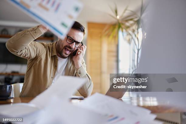 frustrated entrepreneur talking on cell phone at home office. - throwing phone stock pictures, royalty-free photos & images