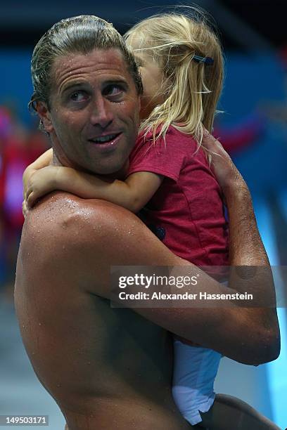 Jesse Smith of the United States celebrates winning the Men's Water Polo Preliminary Round Group B match against Montenegro with his daughter on Day...