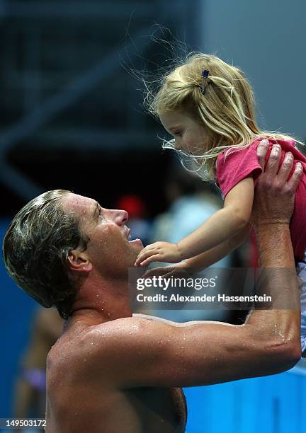 Jesse Smith of the United States celebrates winning the Men's Water Polo Preliminary Round Group B match against Montenegro with his daughter on Day...