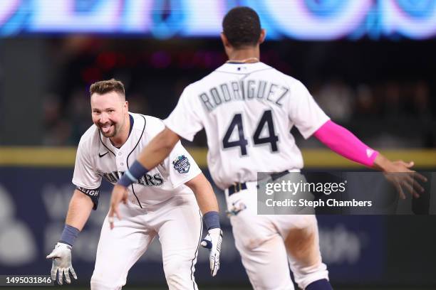Cal Raleigh of the Seattle Mariners reacts after his walk-off single with Julio Rodriguez during the tenth inning against the New York Yankees at...