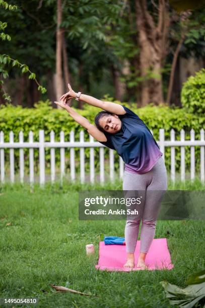 young woman doing yoga and morning workout at park - dipping stock pictures, royalty-free photos & images