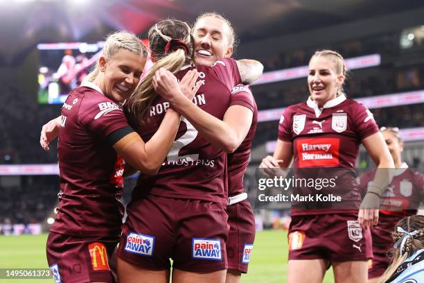 Julia Robinson of the Maroons celebrates with her team mates after scoring a try during game one of the Women's State of Origin series between New...