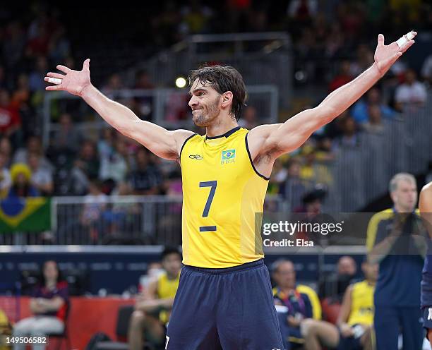 Gilberto Godoy Filho of Brazil celebrates a point in the third set against Tunisia during Men's Volleyball on Day 2 of the London 2012 Olympic Games...