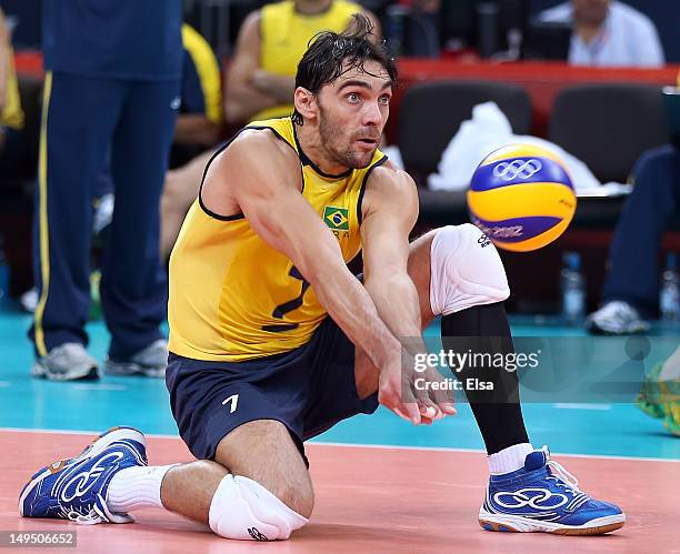 Gilberto Godoy Filho of Brazil returns a shot to Tunisia during Men's Volleyball on Day 2 of the London 2012 Olympic Games at Earls Court on July 29,...