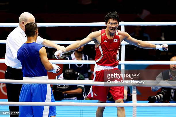 Yasuhiro Suzuki of Japan celebrates his victory over Mehdi Khalsi of Morocco during their Men's Welter Boxing bout on day 2 of the London 2012...