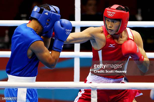 Yasuhiro Suzuki of Japan in action with Mehdi Khalsi of Morocco during their Men's Welter Boxing bout on day 2 of the London 2012 Olympic Games at...