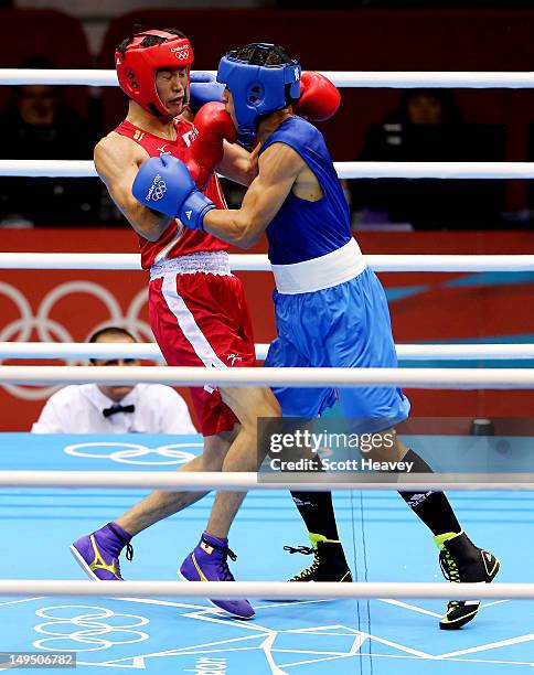 Yasuhiro Suzuki of Japan in action with Mehdi Khalsi of Morocco during their Men's Welter Boxing bout on day 2 of the London 2012 Olympic Games at...