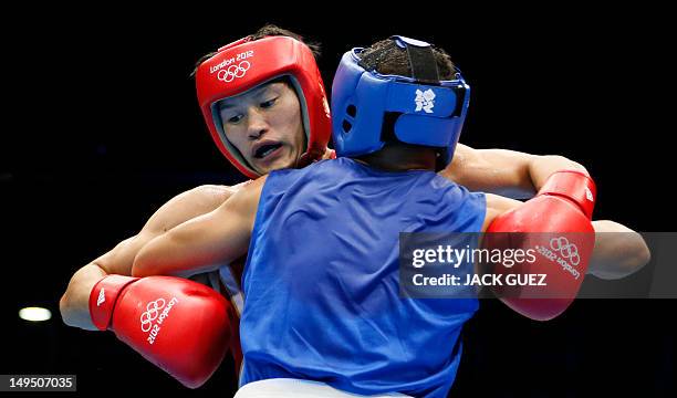 Yasuhiro Suzuki of Japan clinches with Mehdi Khalsi of Morocco during their first round Welterweight match of the London 2012 Olymipic Games on July...