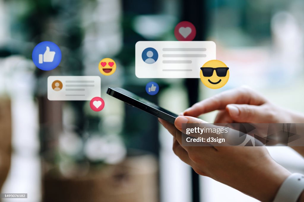 Close up of young woman using smartphone on social media network application. Viewing posts, giving likes or love, making friends on social media pages in the city. People engaging in networking with technology. Social media addiction concept