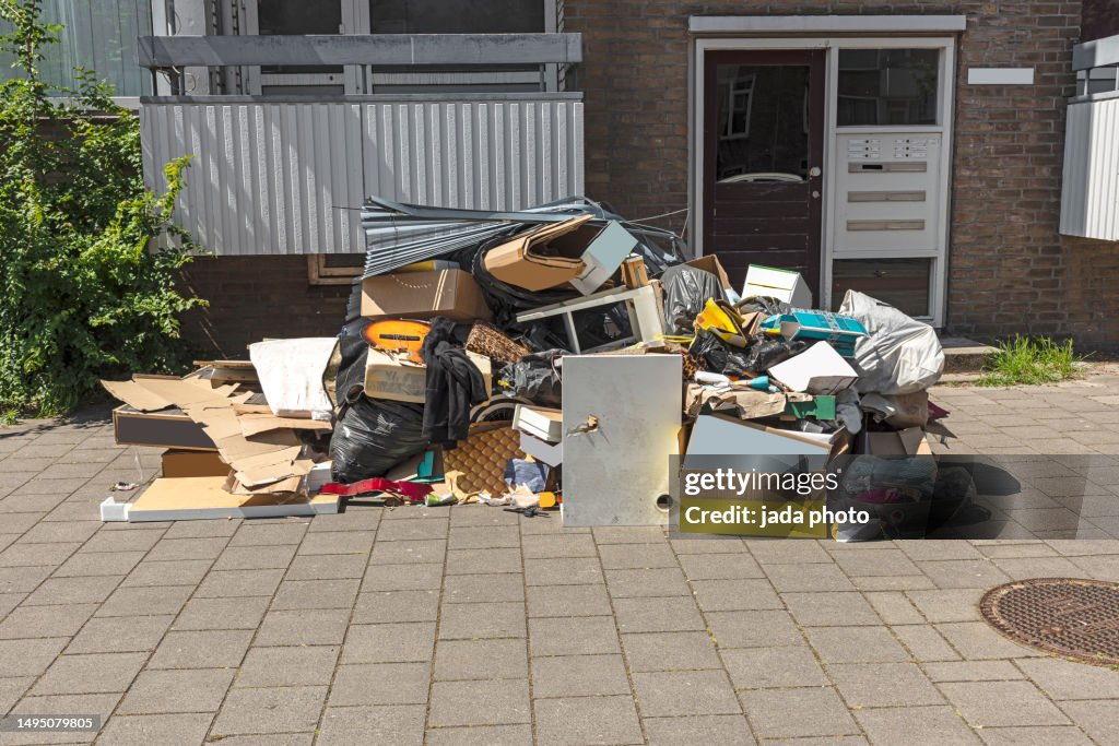 Dumped garbage lying outside on the street