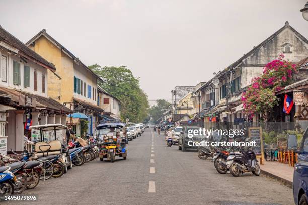 view up main street with old french architecture - laos stock pictures, royalty-free photos & images