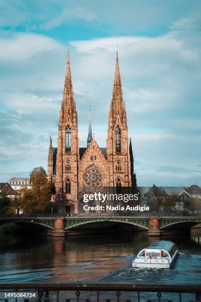 saint paul church with boat on river in strasbourg france - christian audigie stock pictures, royalty-free photos & images