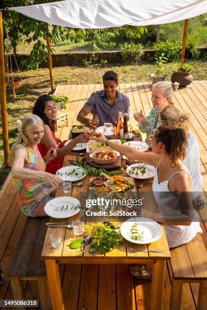 sitting down together - luxury home dining table people lifestyle photography people stock pictures, royalty-free photos & images